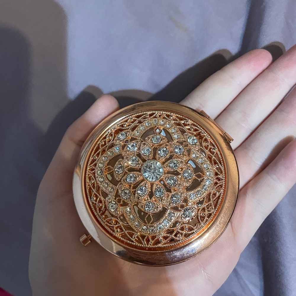 Hand held rose gold mirror